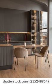 Kitchen Area In A Chic Expensive Interior Of A Luxury Home With A Dark Black And Brown Modern Design With Wood Trim And Led Light