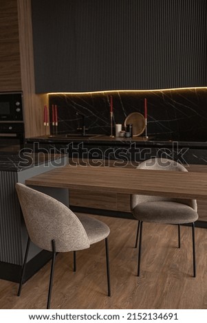 kitchen area in a chic expensive interior of a luxury home with a dark black and brown modern design with wood trim and led light
