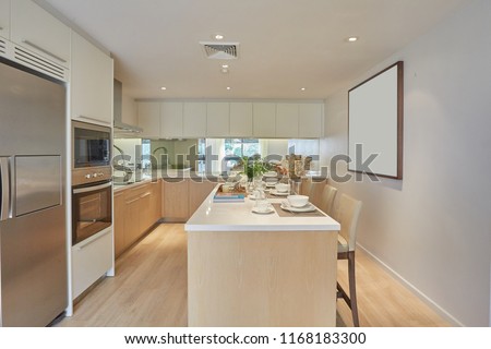 Kitchen area with counter dining table interior design. Fully furnished apartment kitchen room decoration by contemporary style.