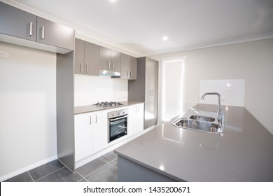 Kitchen Of Australian Home Interior Stone Bench Top Cook Top And Basin