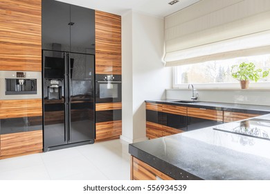 Kitchen With Black Marble Worktop And Fridge