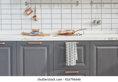 Kitchen Brass Utensils, Chef Accessories. Hanging Copper Kitchen With White Tiles Wall