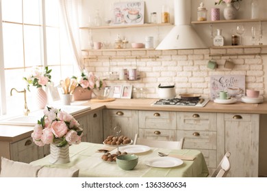 Kitchen With Bright Fresh Flowers. Kitchen Interior In Beige Shades