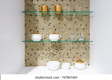 kitchen ceramic and white mug on a glass shelves in a white cabinet with colorful mosaic background. - Powered by Shutterstock