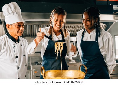 In kitchen chef instructs students. Schoolgirls create ramen. Kids and teacher at stove. Smiling portrait of learning is modern education. Making dinner with ladle is joyful. - Powered by Shutterstock