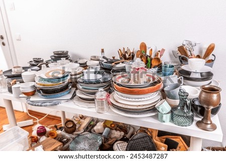 Kitchen clutter, utensils and kitchenware on a table. Concept of tidying and decluttering