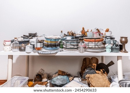 Kitchen clutter, utensils and kitchenware on a table. Concept of tidying and decluttering