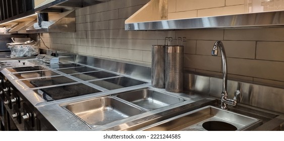 Kitchen cooking line, induction cookers, noodle boiler, bain marie and shelves - Shutterstock ID 2221244585