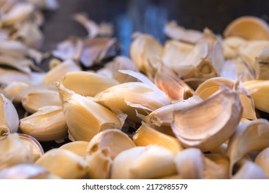 Kitchen Counter Top With A Bunch Of Unpeeled Garlic Cloves