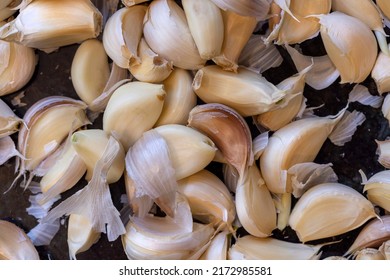 Kitchen Counter Top With A Bunch Of Unpeeled Garlic Cloves