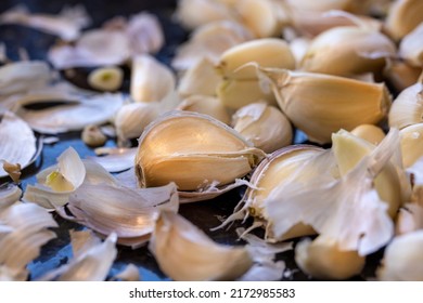 Kitchen Counter Top With A Bunch Of Unpeeled Garlic Cloves