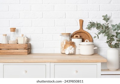 Kitchen counter top with space, containers and utensils on white brick wall background - Powered by Shutterstock