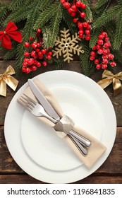 Kitchen Cutlery With Plate And Christmas Decorations On Wooden Table