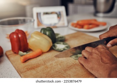 Kitchen, cutting board and vegetables being cut for cooking a healthy, organic and delicious meal. Food, nutrition and chef chop or preparing fresh produce peppers for a diet dinner, lunch or supper. - Powered by Shutterstock