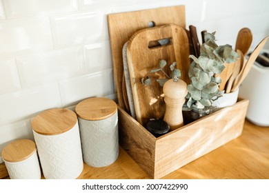 kitchen details, accessories, ceramic jars, wooden table, white ceramic brick wall background. Sustainable living eco friendly kitchen.