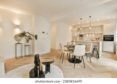 a kitchen and dining area in a living room with white walls, wood flooring and an open - plan kitchen - Powered by Shutterstock