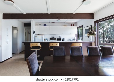 Kitchen and dining area of older style retro funky Australian beach house