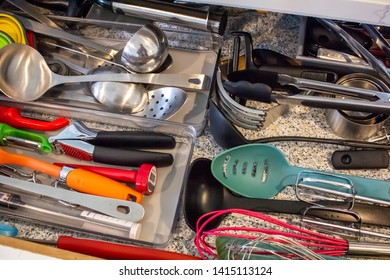 A Kitchen Drawer Full Of Cooking Utensils