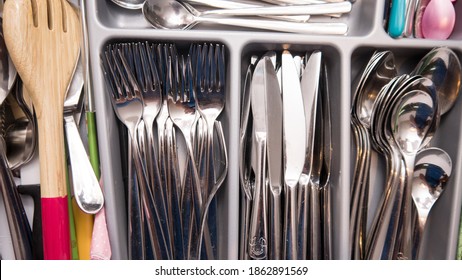 A Kitchen Drawer Full Of Different Cutlery, Such As Knives, Forks And Spoons.