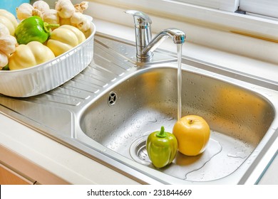 Kitchen Faucet With A Flowing Water Washing