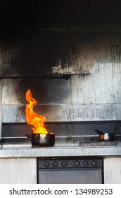 Kitchen Fire In A Pot. Concept Photo Of Unattended Cooking, Risk Of Fire, Fire Kitchen And Danger At Home, Risk  Prevention, Cooking Safety And Home Accidents.No People. Copy Space