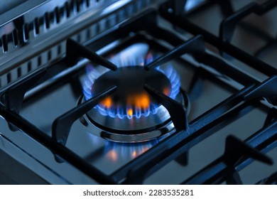 kitchen gas stove alight with flame coming out of it. Conceptual photo for gas, cost of bills, rising prices, heat and the environment. metal Ukraine, Russia, Europe. blu flame. united states. cook  - Shutterstock ID 2283535281