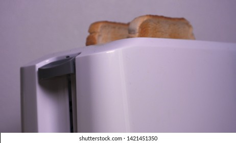 In The Kitchen, A Guy (girl) Pulls Out Food From The Refrigerator And Prepares Breakfast Next To The Toaster, Ready-made Toasters Are Pulled Out. Concept Of: Homemade Food, Comfort, Breakfast, Slow Mo