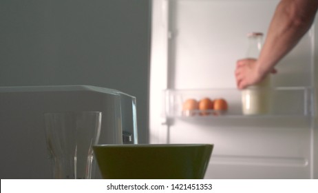 In The Kitchen, A Guy (girl) Pulls Out Food From The Refrigerator And Prepares Breakfast Next To The Toaster, Ready-made Toasters Are Pulled Out. Concept Of: Homemade Food, Comfort, Breakfast, Slow Mo