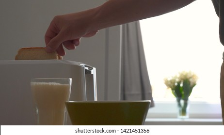 In The Kitchen, A Guy (girl) Pulls Out Food From The Refrigerator And Prepares Breakfast Next To The Toaster, Ready-made Toasters Are Pulled Out. Concept Of: Homemade Food, Comfort, Breakfast, Slow Mo