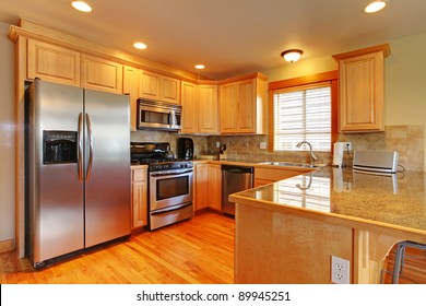 Kitchen With Hardwood Floor And Granite.