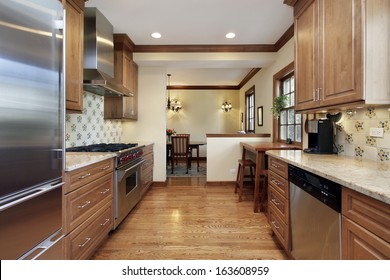 Kitchen In Home With Oak Wood Cabinetry