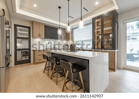 kitchen interior with dark cabinets large kitchen island with white marble and bar stools black leather hardwood floor pendant lighting window covering spacious modern new construction family home