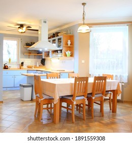 Kitchen Interior In Family House. Table With Four Chairs. Residential Architecture And Housing For The Middle Class.