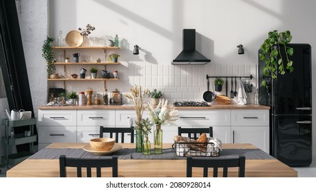 Kitchen interior with modern furniture, appliances and decor on table. Bright and spacious apartment. Luxury real estate for sale. Dining room design project - Shutterstock ID 2080928014