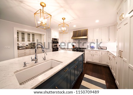 Kitchen Interior with in New Luxury Home. Features Elegant Pendant Light Fixtures