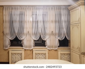 Kitchen interior with table and tulle on the window