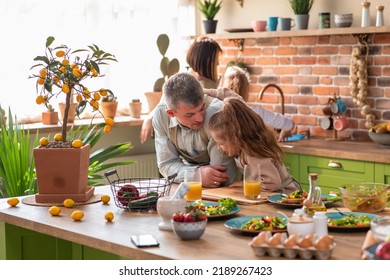 At The Kitchen Island Very Luminous In Front Of The Camera Beautiful And Charismatic Family All Together Have A Healthy Breakfast In The Morning Before They Go To School And Work