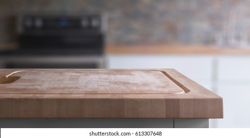 Kitchen Island Wood Butcher Block Top With Stove, Sink And Counter In Background, Selective Focus On Foreground