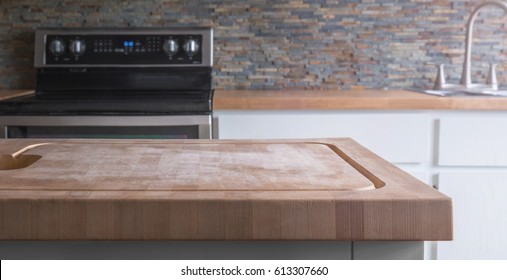 Kitchen Island Wood Butcher Block Top With Stove, Sink And Counter In Background