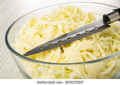 Kitchen Knife, Chopped White Cabbage In Transparent Glass Bowl On Wooden Table