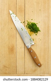 Kitchen Knife With Diced Chives On Cutting Board