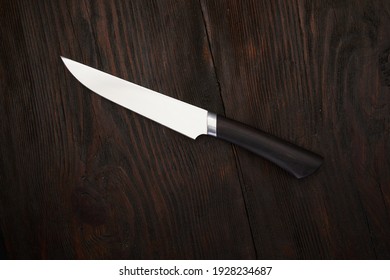 Kitchen Knife Macro On Brown Wood Texture Background