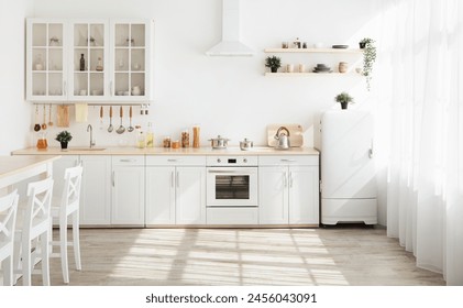 Kitchen with light walls, white furniture and shelves with crockery and plants in pots, small refrigerator in dining room scandinavian design, empty space. Modern interior with sunbeams on the floor - Powered by Shutterstock