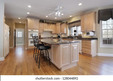 Kitchen In Luxury Home With Oak Wood Cabinetry