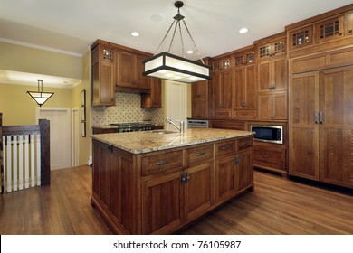 Kitchen In Luxury Home With Oak Wood Cabinetry