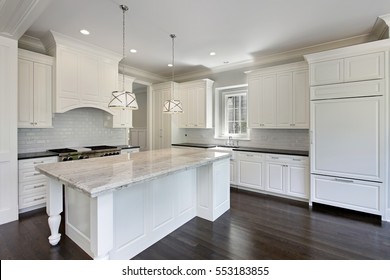 Kitchen In Luxury Home With White Cabinetry.