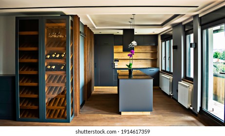 Kitchen Modern Interior With Vertical Display Wood Wine Rack And Kitchen Island. 