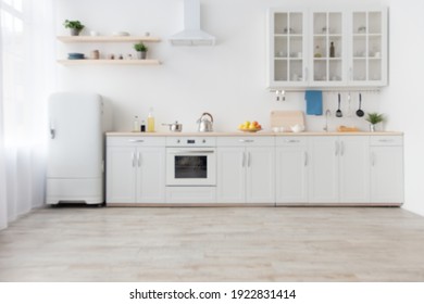 Kitchen modern scandinavian interior with white furniture with utensils, shelves with crockery and plants in pots, refrigerator in dining room. Simple design, rent and sale, blog at flat, empty space - Shutterstock ID 1922831414