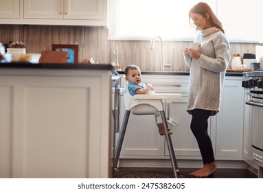 Kitchen, mom and happy with baby in high chair in home with playing and busy with house keeping. Parent, woman and toddler for child development or growth with care, support and trust or bonding