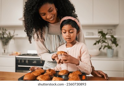 Kitchen, mom and kid, cupcake baking in house and eating together, happy with dessert in apartment. Child development, cooking sweet treats and bonding time, woman baker and girl in home with cake. - Powered by Shutterstock